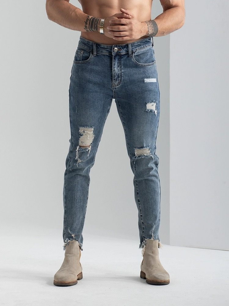 Wholesale Stock 2023 New Fashion Denim Jeans High Stretch Fringe Hem Puncture Design Jeans for Men